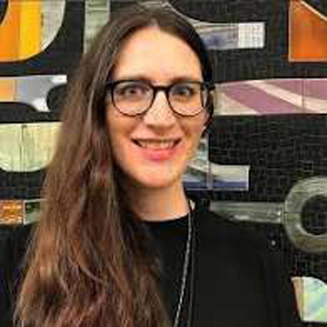 bridget-smiling-with-glasses-and-a-black-turtleneck